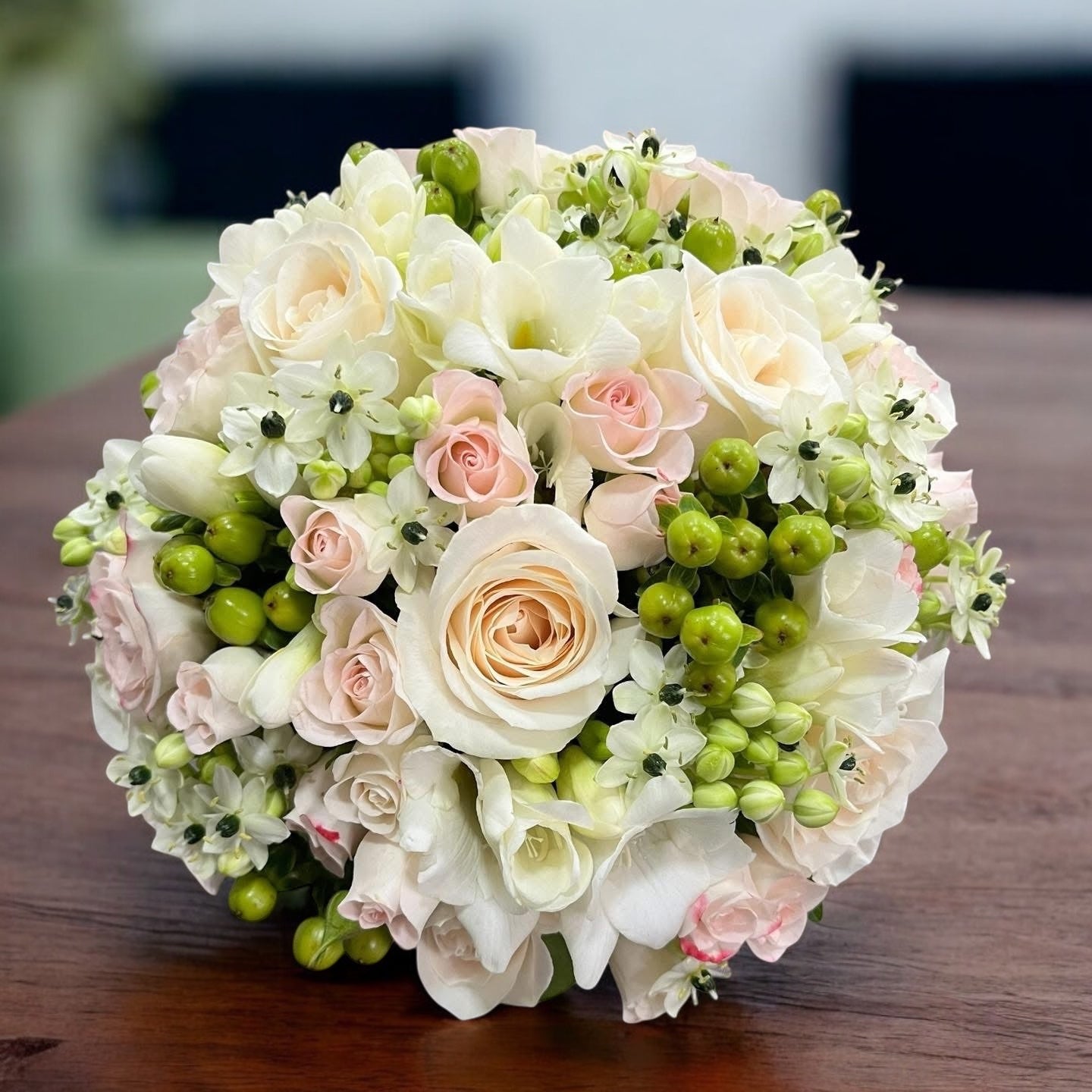 Classic bridal bouquet with roses, freesia, ornithogalum and hypericum