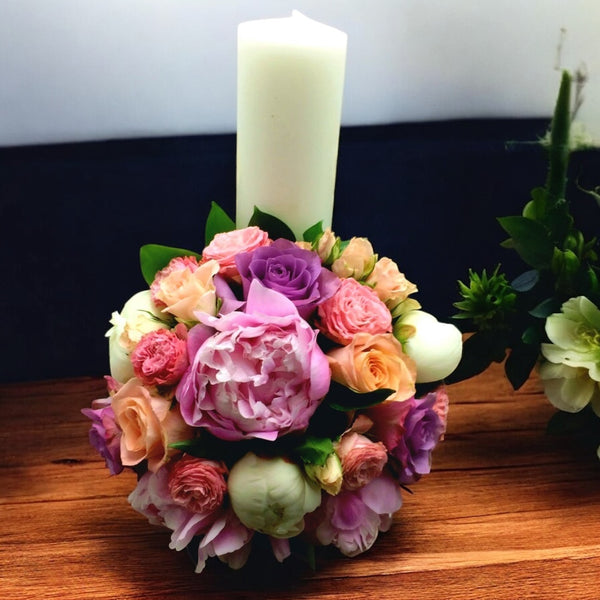 Candle christening peonies and roses