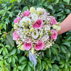 Wedding bouquet of pink roses and white lisianthus