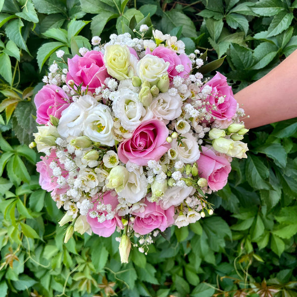 Wedding bouquet of pink roses and white lisianthus