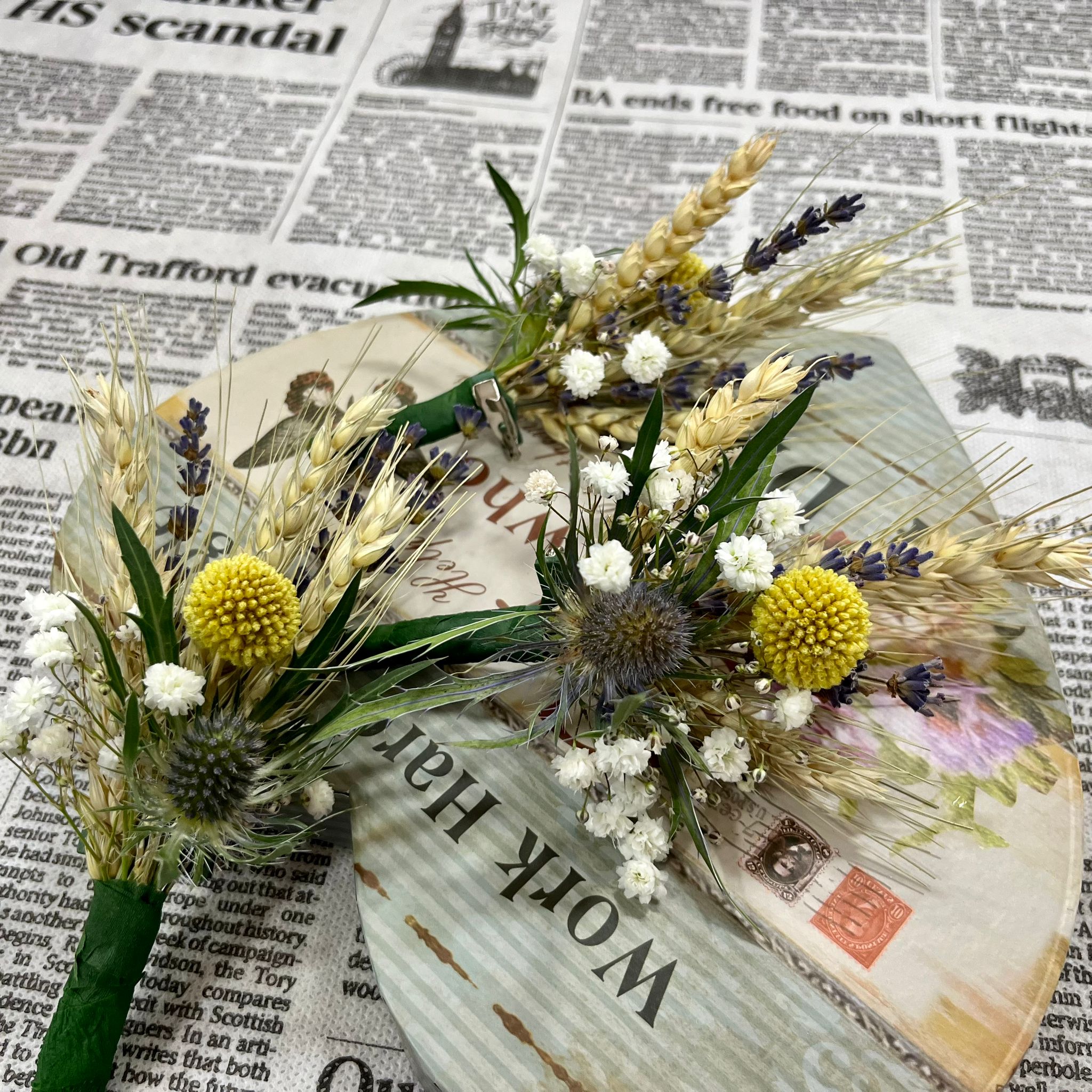 Bunches of natural flowers - ears of wheat, eryngium and craspedia