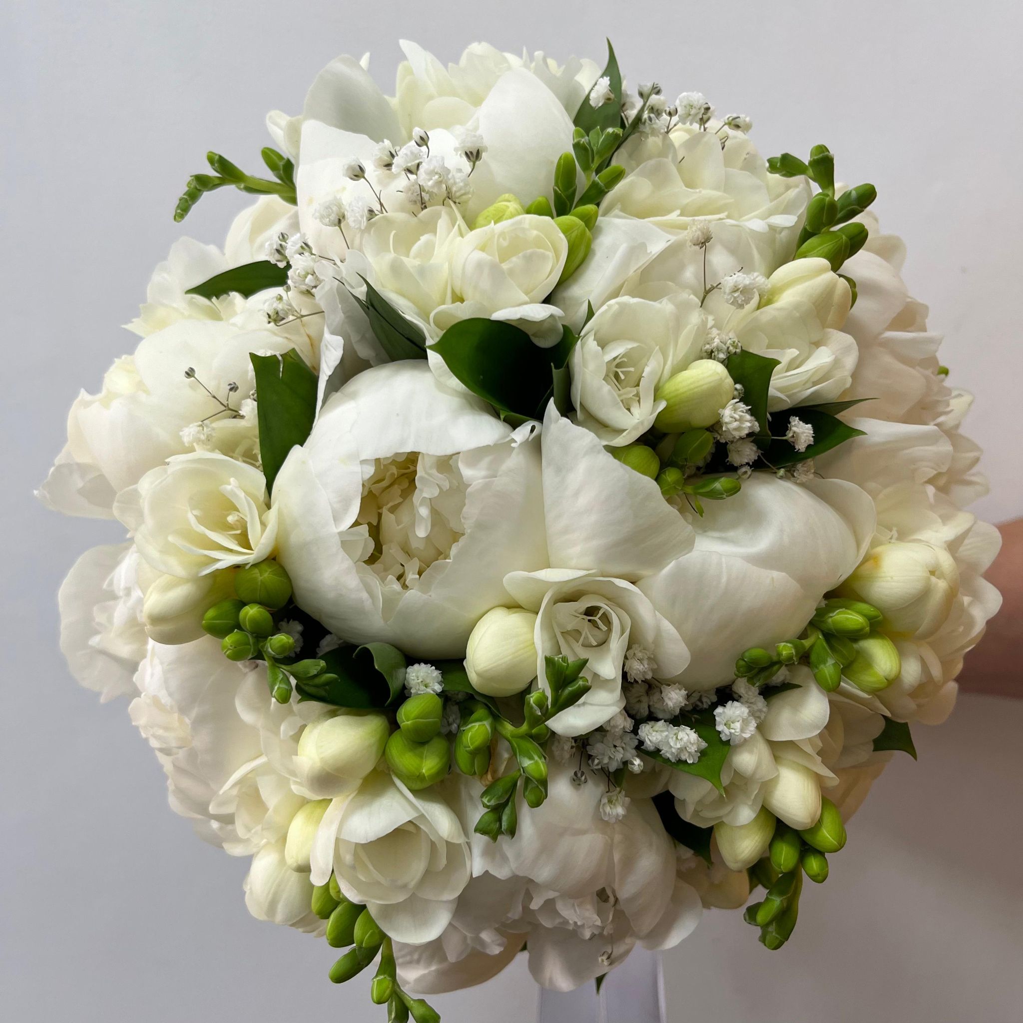 Wedding bouquet of white peonies and the bride's flower