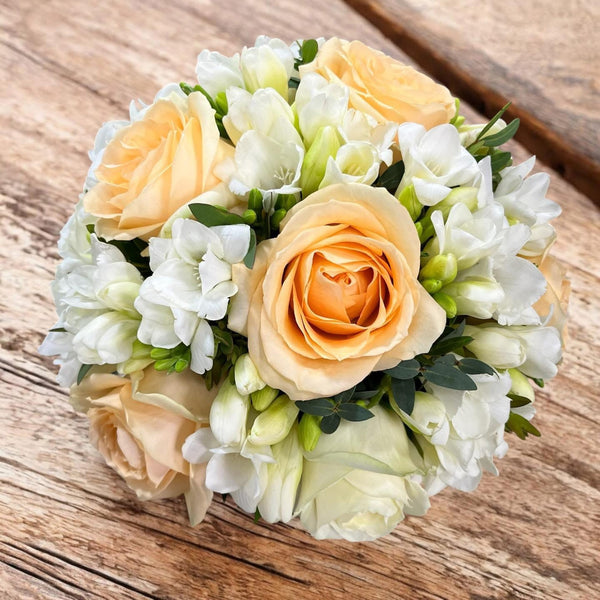 Bridal bouquet of peach and ivory roses
