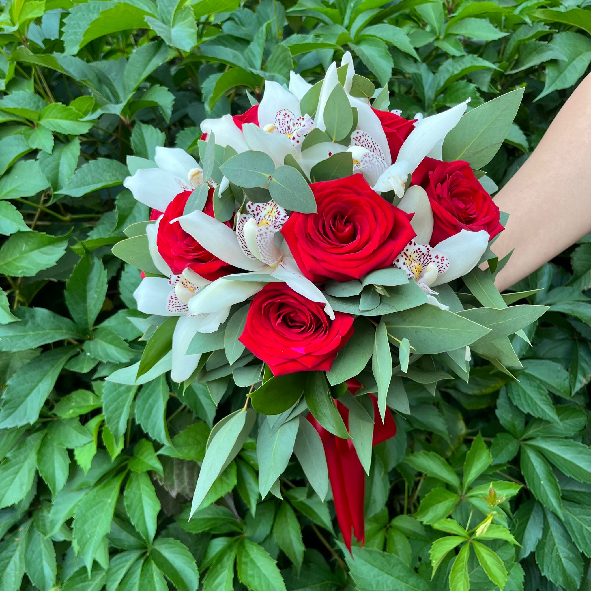 Wedding bouquet of red roses and cymbidium