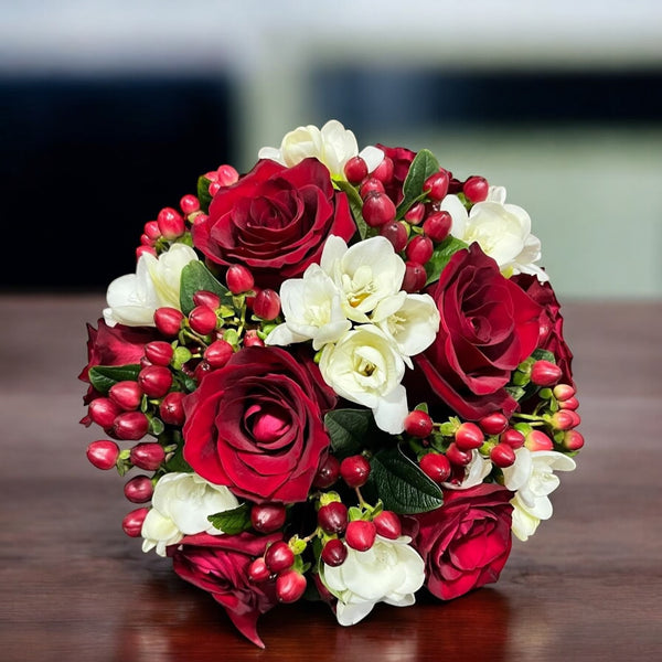 Wedding bouquet with red roses and white freesias