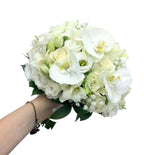Wedding bouquet with roses, lisianthus and phalaenopsis orchids