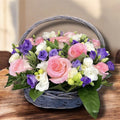 Arrangement with roses, lisianthus and freesias