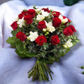 Bouquet of red roses and white freesias