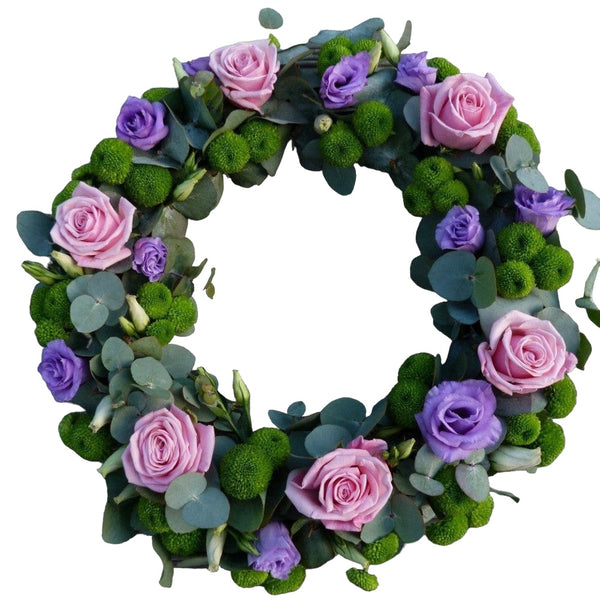 Round funeral wreath with santini, roses and lisianthus