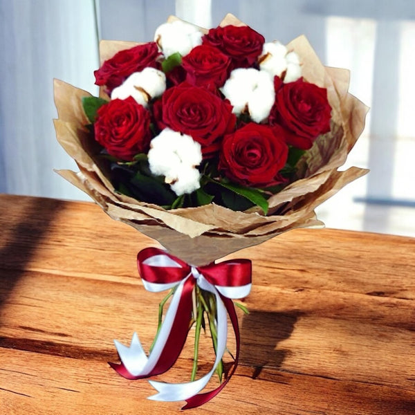 Bouquet of red roses and cotton flowers - love and luck