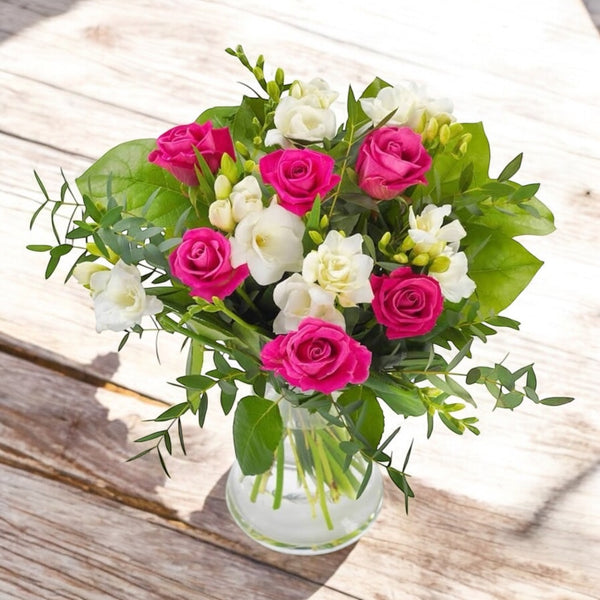 Bouquet of pink roses and white freesias