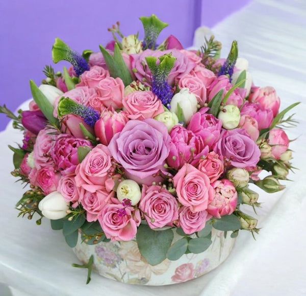 Flower box with tulips, roses and mini roses