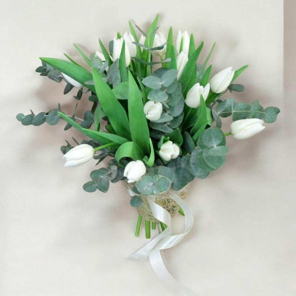 Spring bouquet with white tulips and eucalyptus