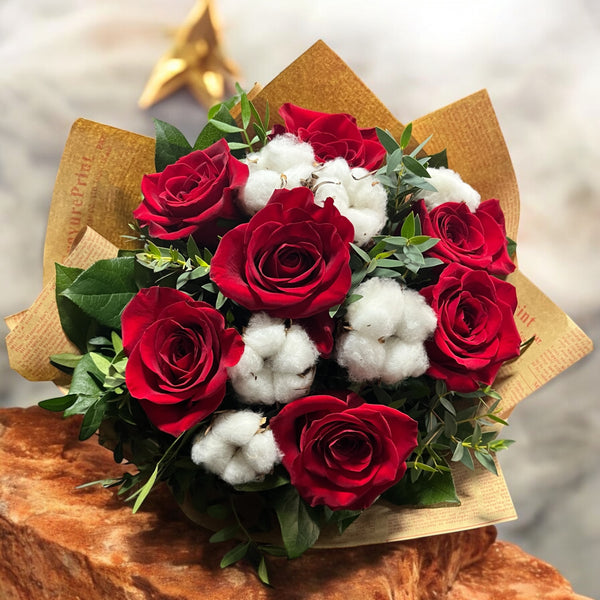 Bouquet of red roses and cotton flowers - love and luck