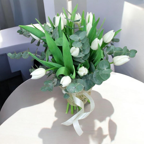 Spring bouquet with white tulips and eucalyptus