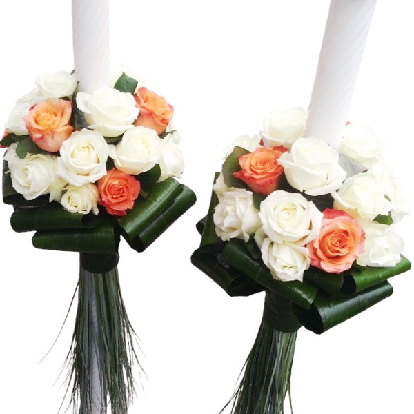 Wedding candles made of white and orange roses