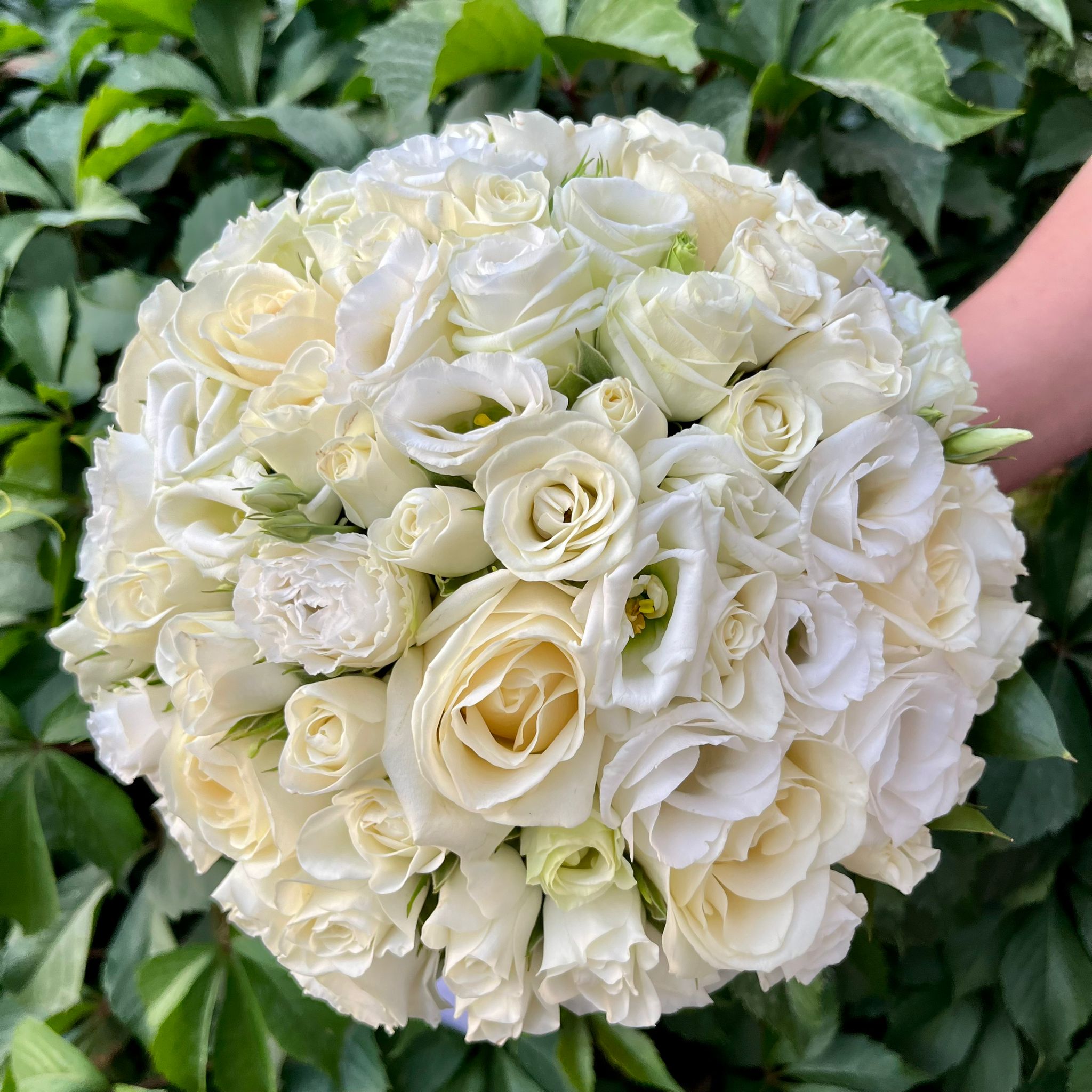 Bridal bouquet with ivory roses and white mini roses