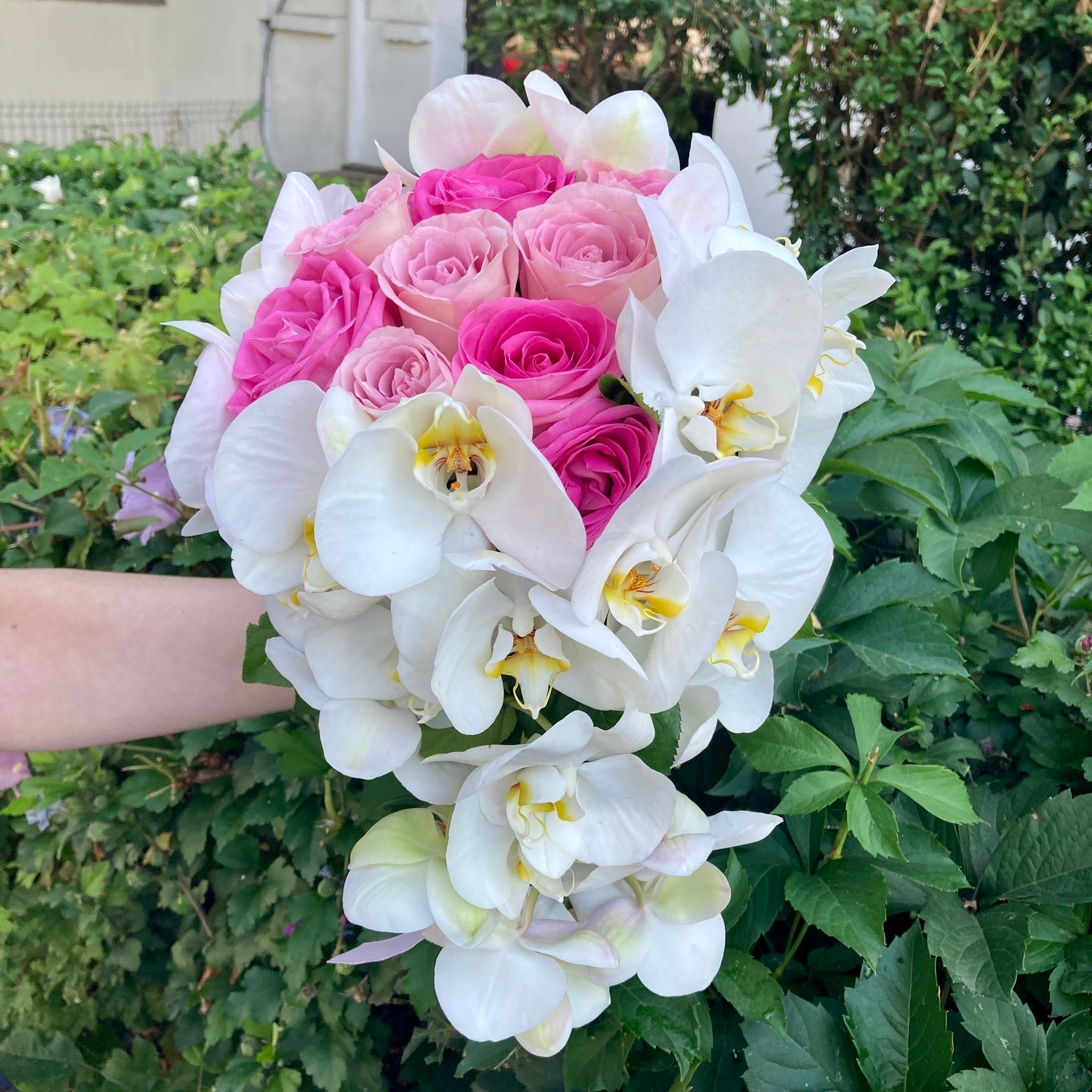 Flowing bridal bouquet with roses and phalaenopsis orchids