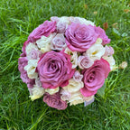 Colorful bridal bouquet of roses, freesias and lisianthus
