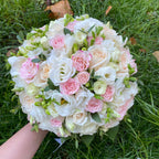 Colorful bridal bouquet of roses, freesias and lisianthus