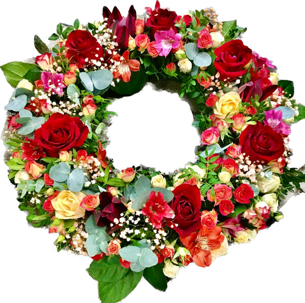 Funeral wreath round orange roses