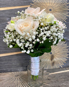 Wedding bouquet of cream roses and white freesias