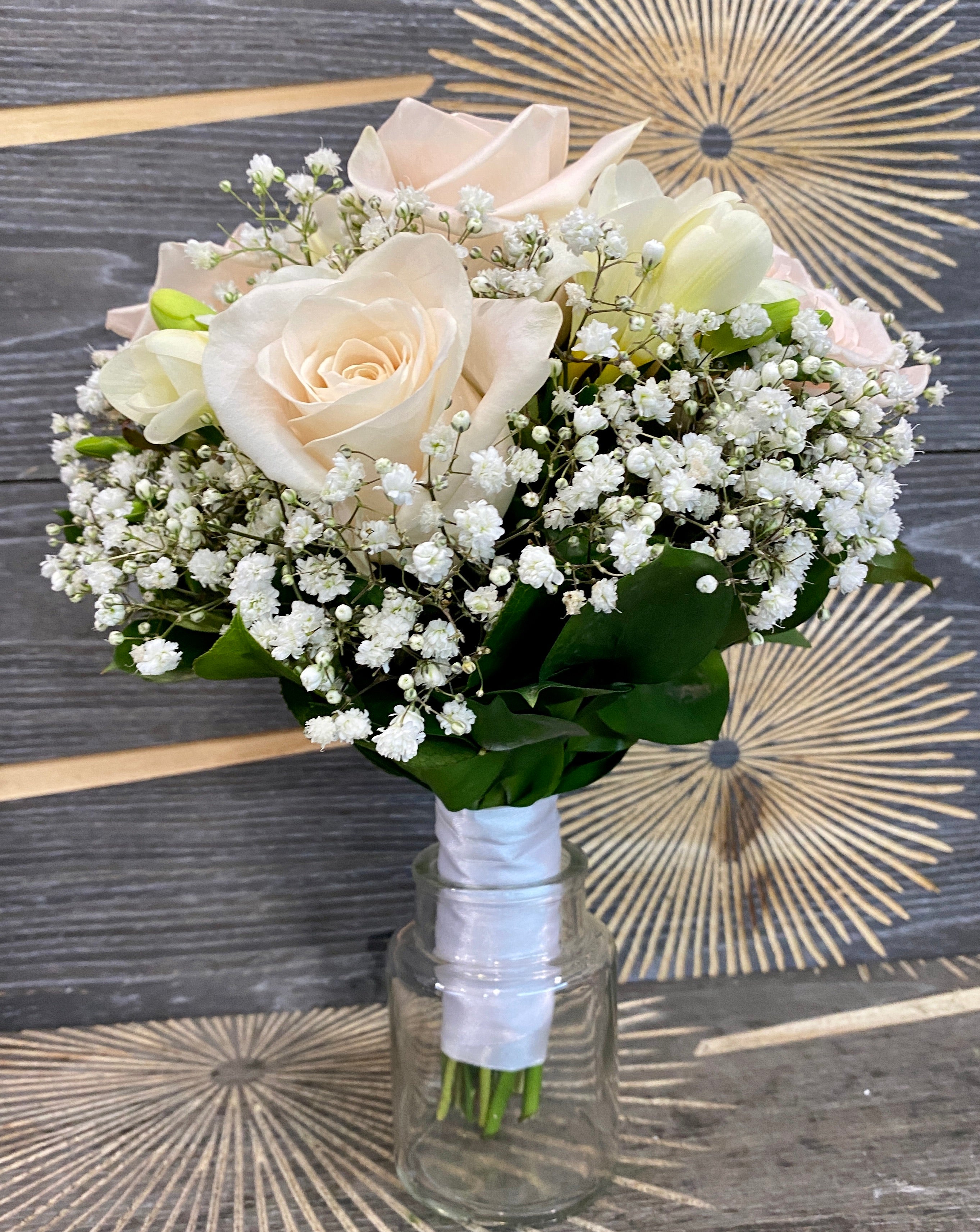 Wedding bouquet of cream roses and white freesias