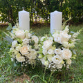 Short white roses and lisianthus wedding candles