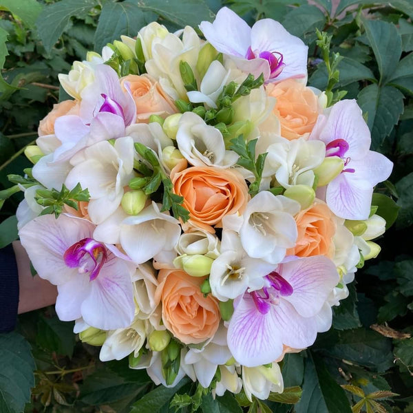 Bridal bouquet of phalaenopsis orchids and peach roses