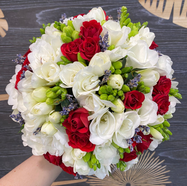 Cheerful wedding bouquet with mini cyclamen roses and freesias