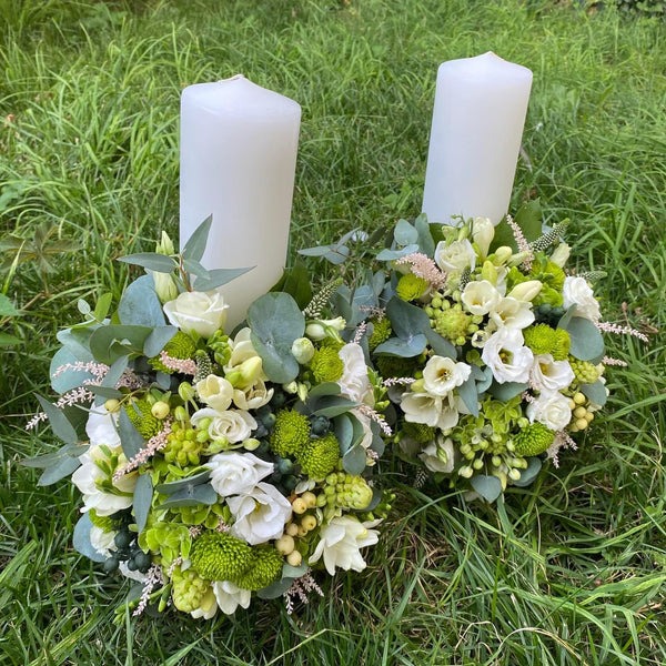 Fresh short wedding candles in shades of white and green