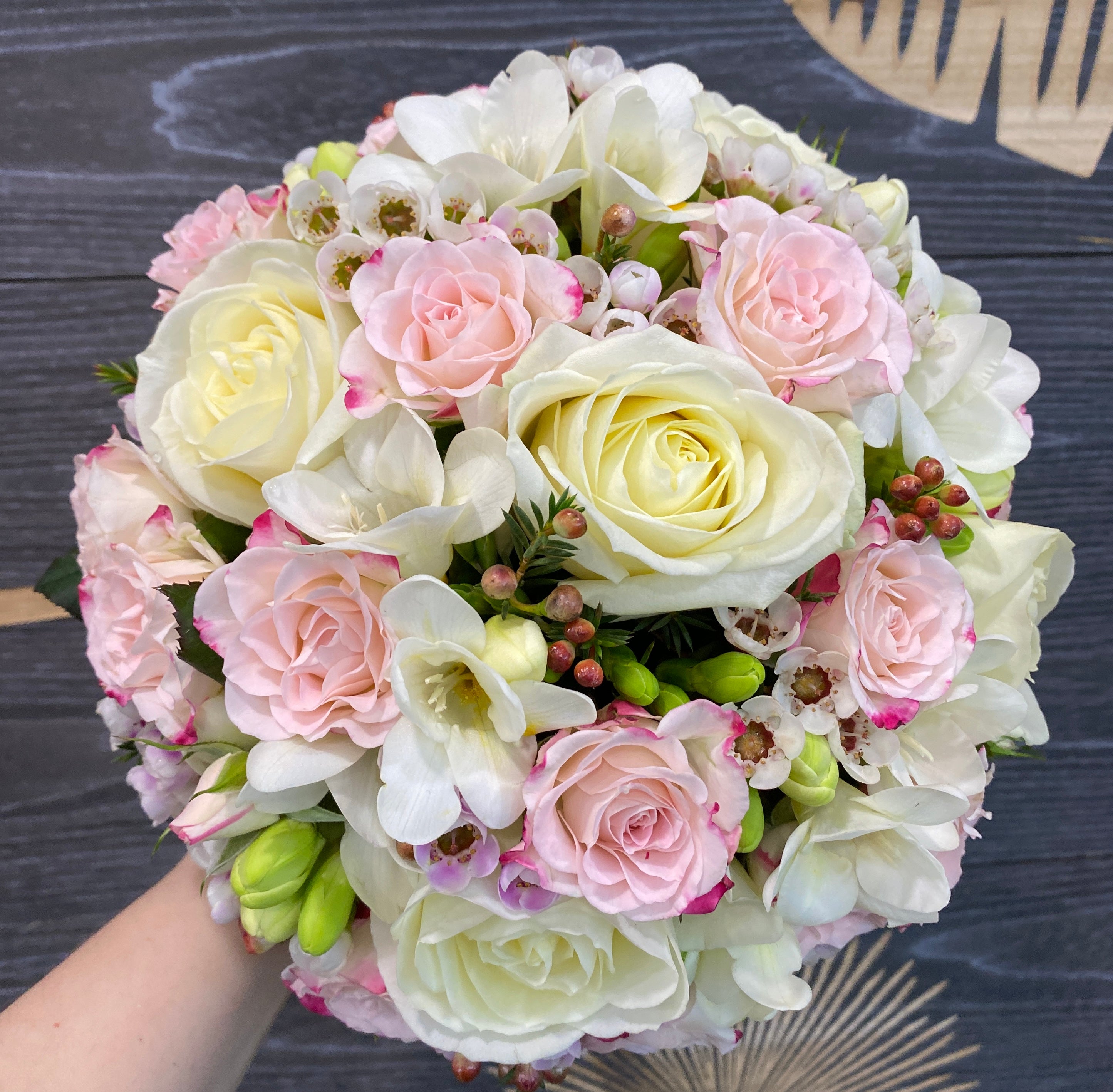 Wedding bouquet of cream roses and red mini roses