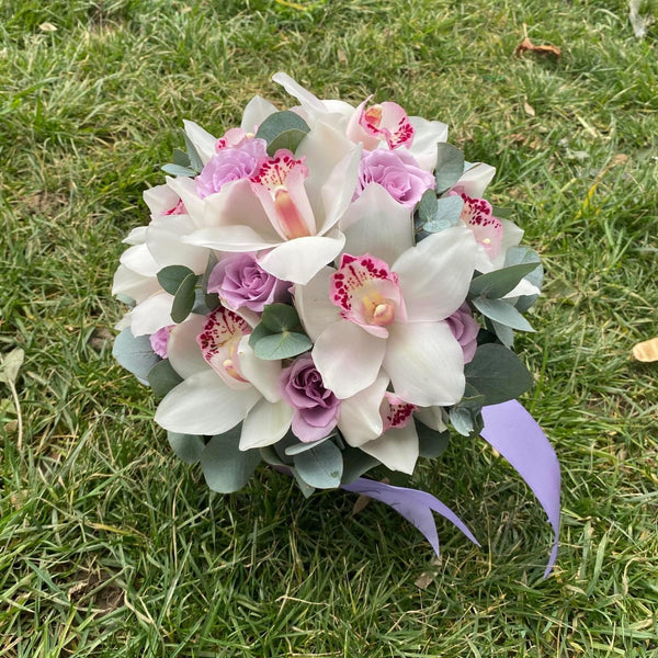 Purple roses and cymbidium wedding bouquet