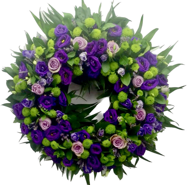Round funeral wreath lisianthus and roses