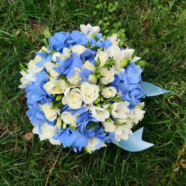 Blue hydrangea and white freesia bridal bouquet