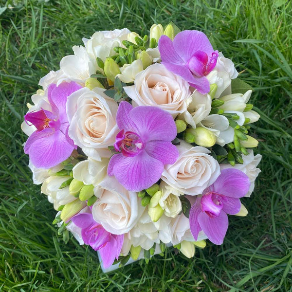 Bridal bouquet of purple roses and orchids