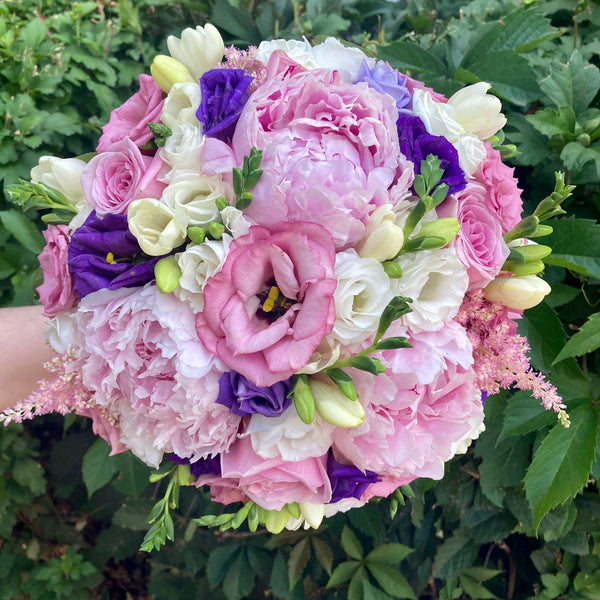 Wedding bouquet with peonies, roses and lisianthus