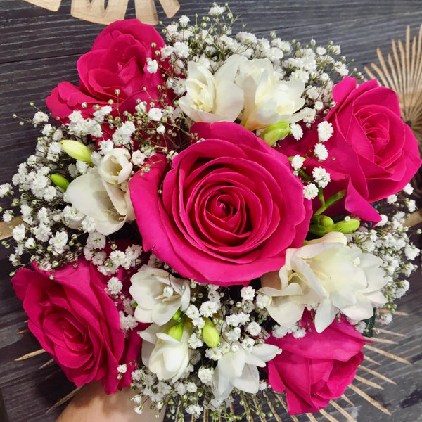 Wedding bouquet of cream roses and white freesias