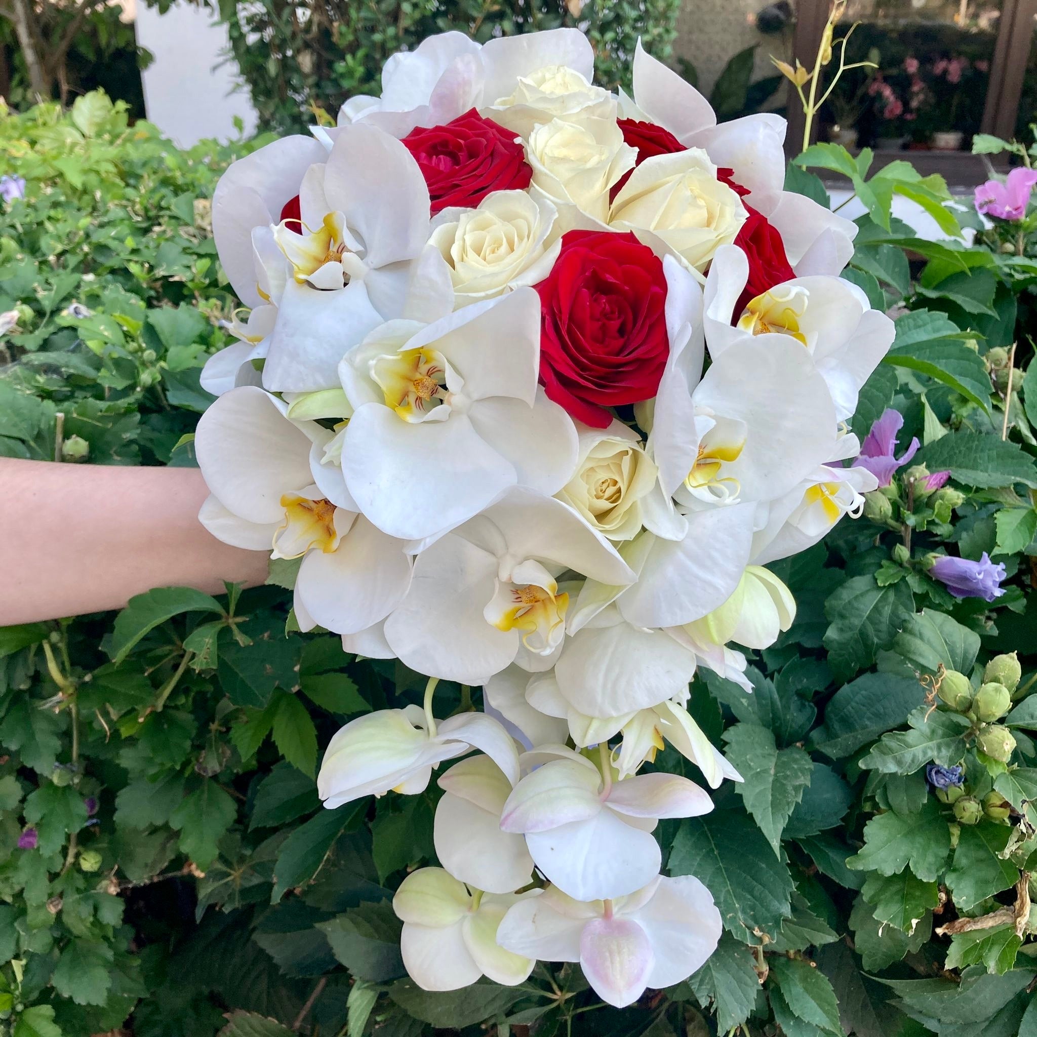Flowing bridal bouquet with roses and phalaenopsis orchids