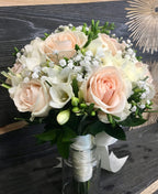 Bridal bouquet with purple roses and white freesias