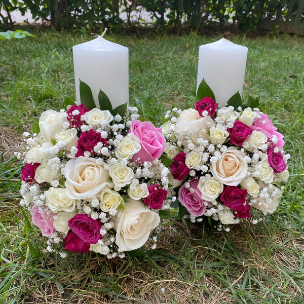 Short white roses and lisianthus wedding candles