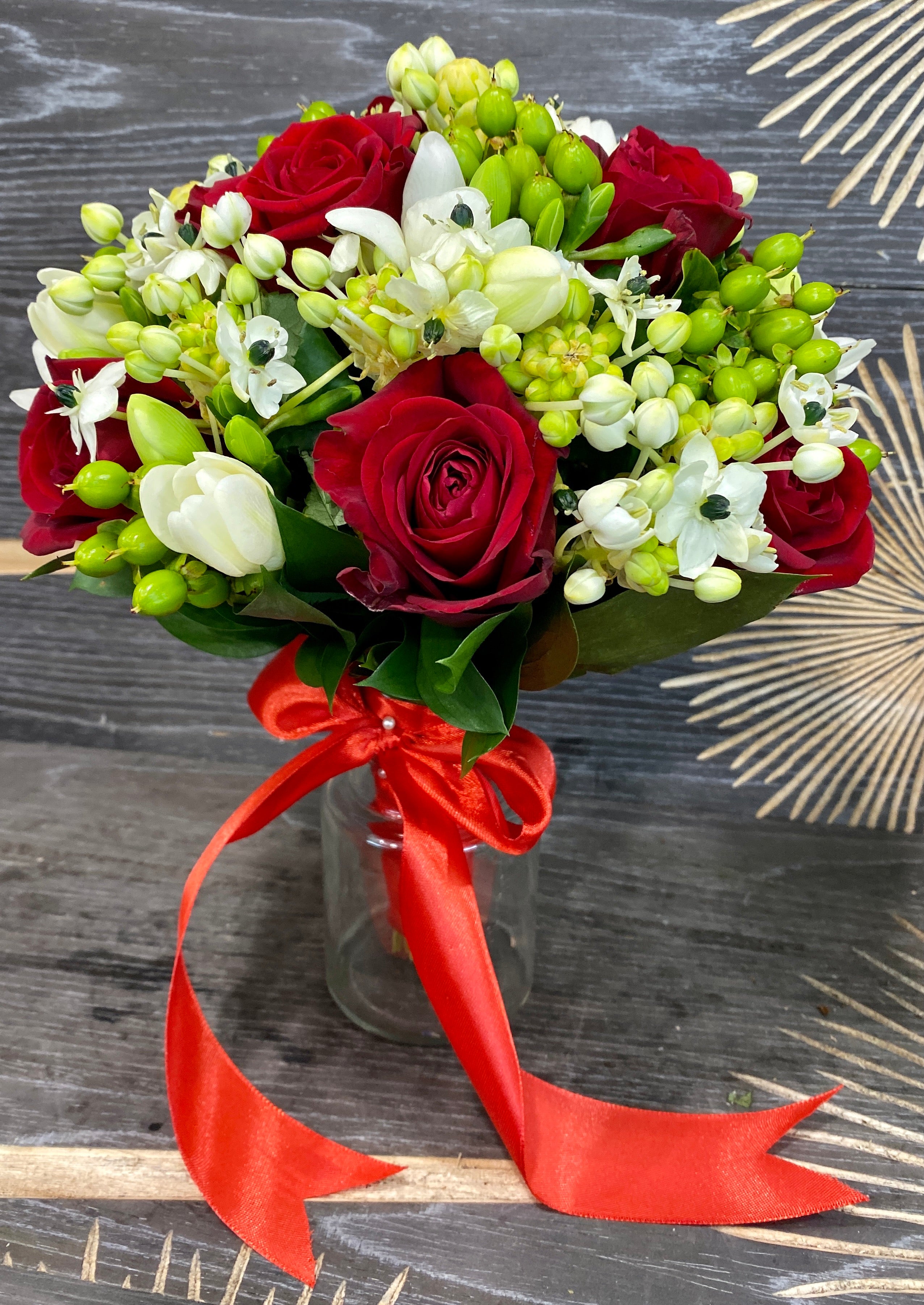 Classic bridal bouquet with roses, freesia, ornithogalum and hypericum
