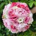 Wedding bouquet with peonies, roses and lisianthus