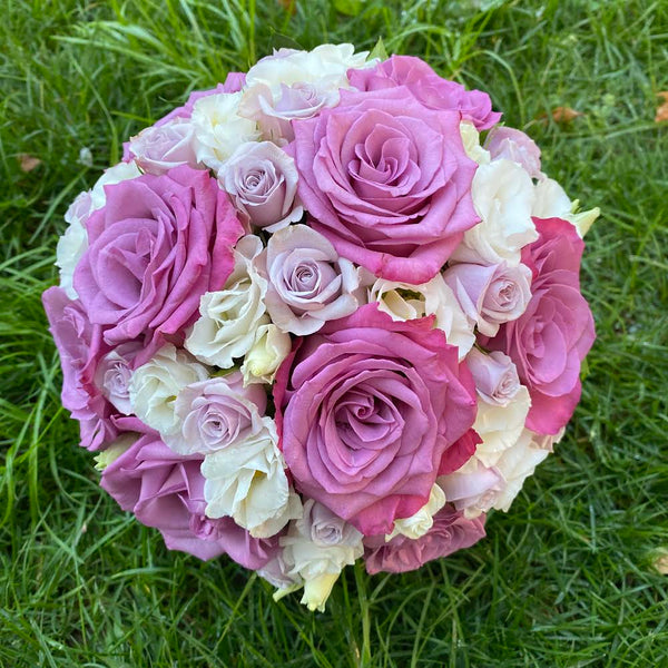Colorful bridal bouquet of roses, freesias and lisianthus