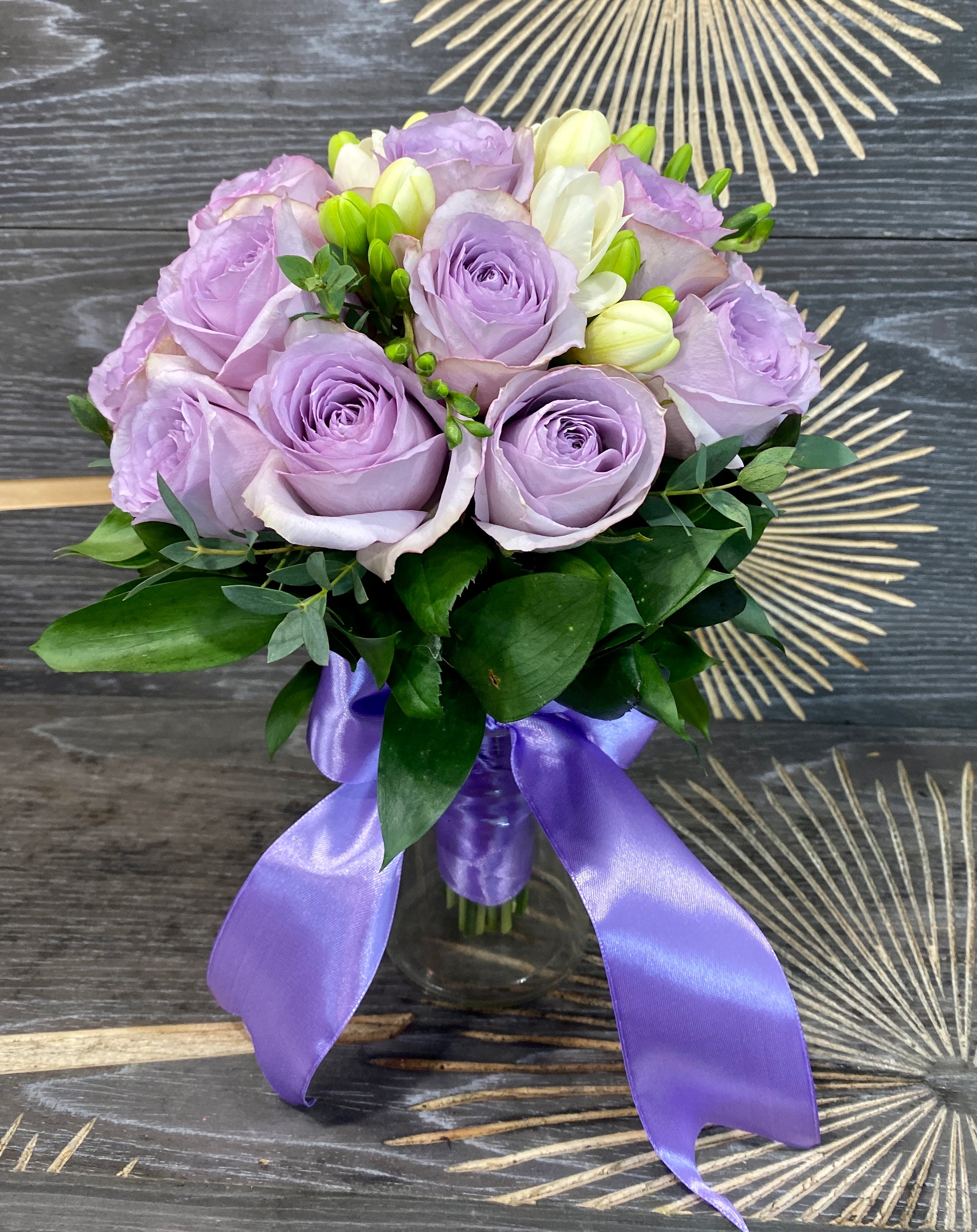 Bridal bouquet of purple roses and freesias