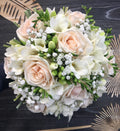 Bridal bouquet with purple roses and white freesias