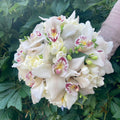 Bridal bouquet with cymbidium orchids and white freesias