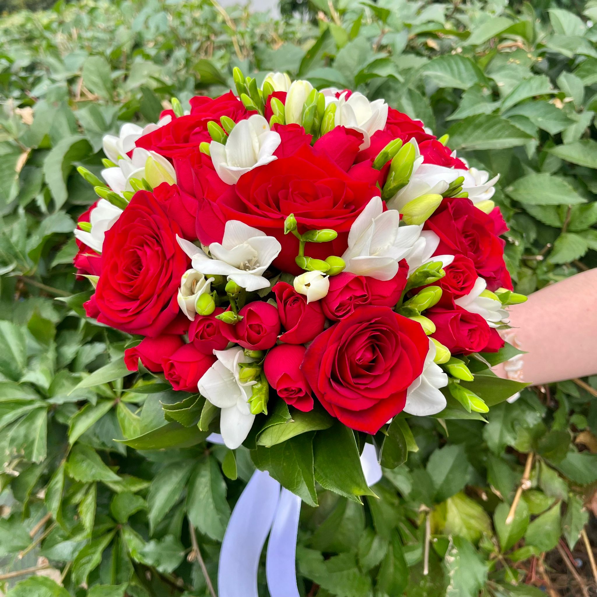 Wedding bouquet of roses, mini roses and freesias
