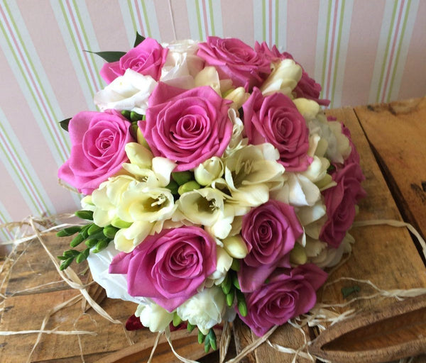 Bridal bouquet of roses, freesias and lisianthus