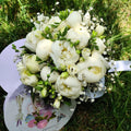 Wedding bouquet of white peonies and the bride's flower